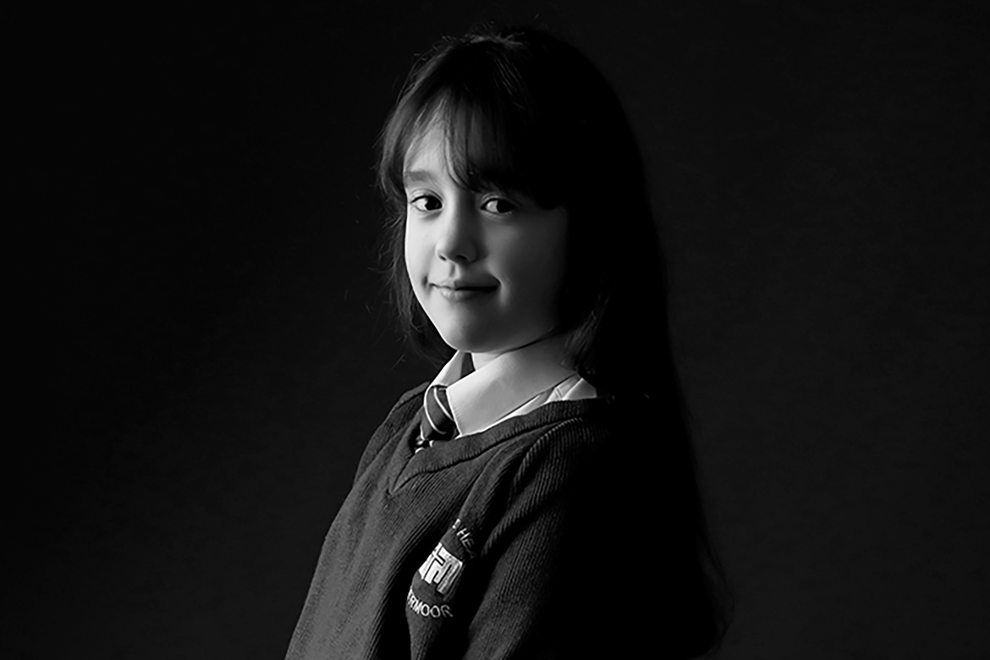 black and white portrait of primary school aged girl with dark hair by Primary School Photographer Gateshead, newcastle and County Durham