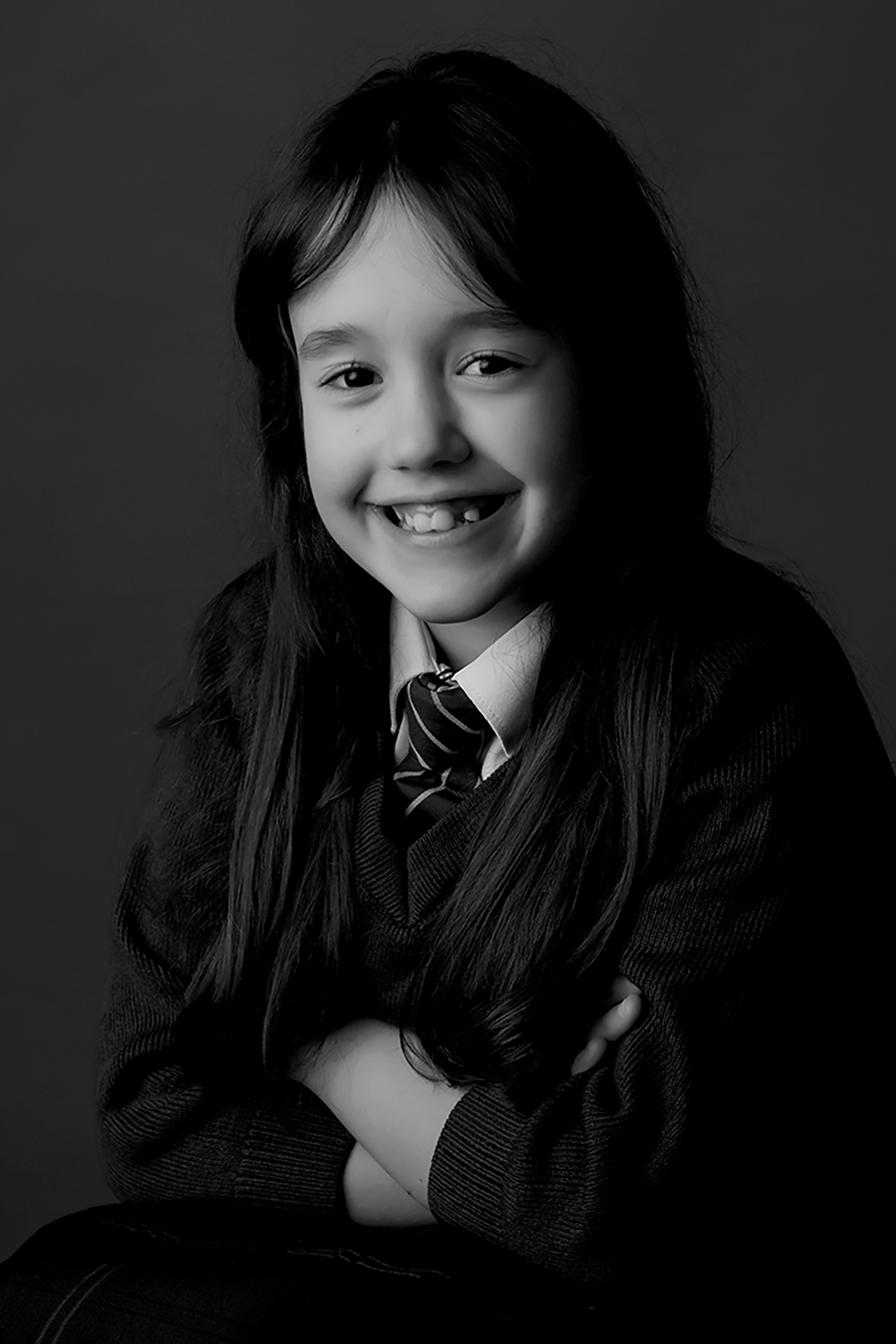 girl smiling having her photo taken at a school in newcastle upon tyne