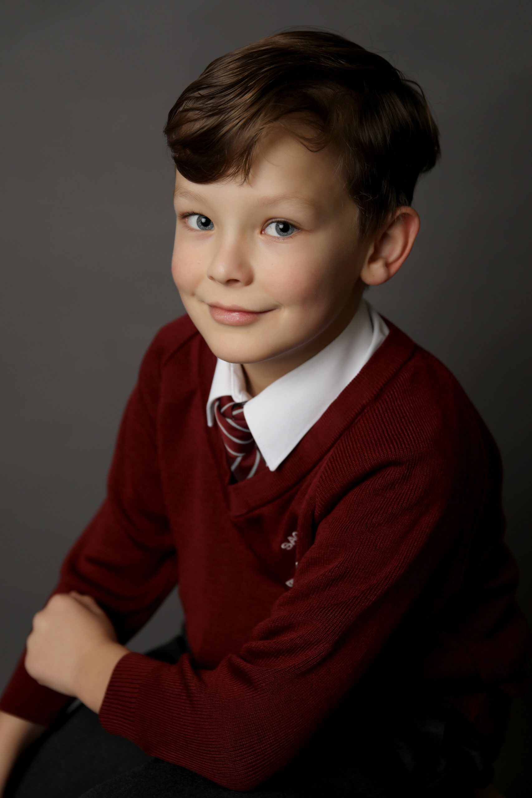 YOUNG BOY IN A BURGUNDY SCHOOL uniform in his school photo by Primary School Photographer Gateshead, Newcastle and County Durham